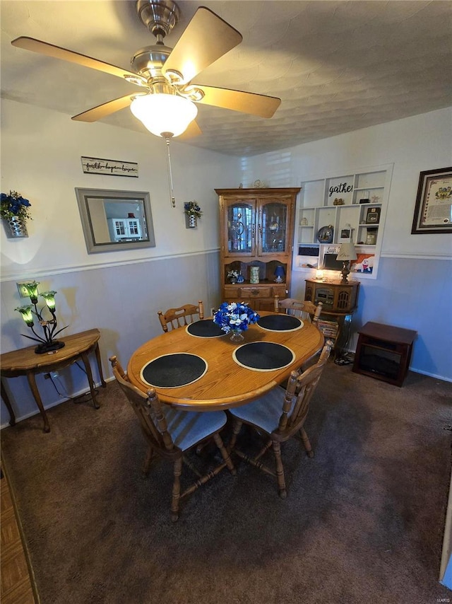 carpeted dining room with a ceiling fan