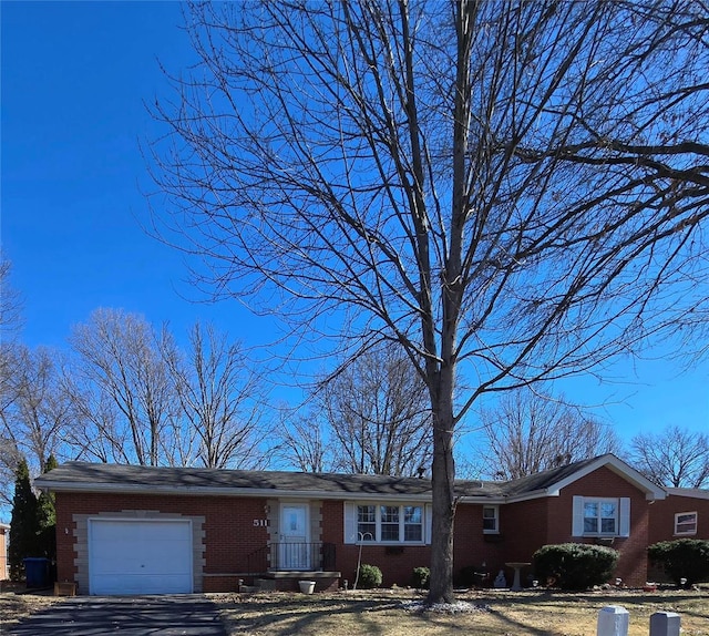 ranch-style home with an attached garage and brick siding