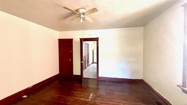 unfurnished room with ceiling fan, baseboards, and wood finished floors