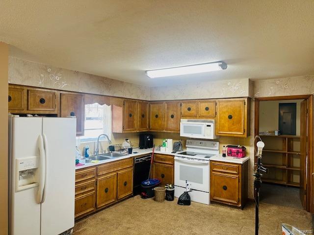 247 Harrison Ln, Poplar Bluff, MO 63901 - kitchen featuring white appliances, a sink, brown cabinets, and light colored carpet