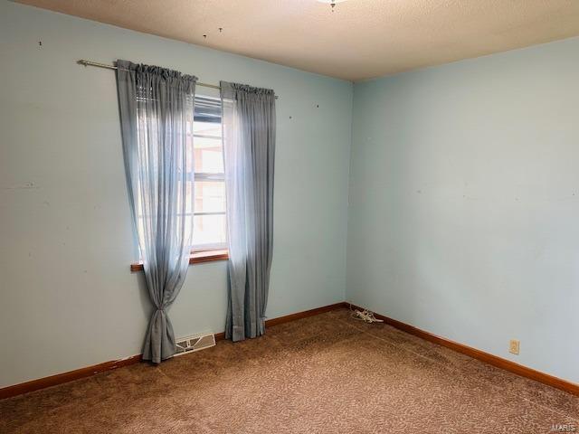 247 Harrison Ln, Poplar Bluff, MO 63901 - carpeted spare room with baseboards