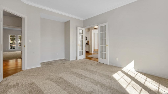 unfurnished bedroom featuring carpet, french doors, ornamental molding, and baseboards