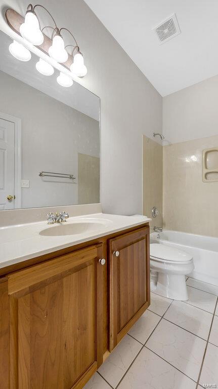 bathroom featuring shower / bath combination, vanity, and toilet