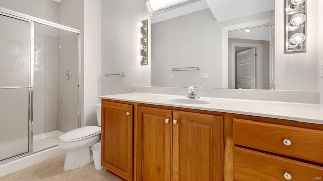 full bathroom with toilet, a shower stall, vanity, and tile patterned floors