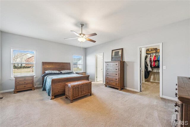 102 Carlton Point Dr, Wentzville, MO 63385 - carpeted bedroom featuring a walk in closet, a ceiling fan, and a closet