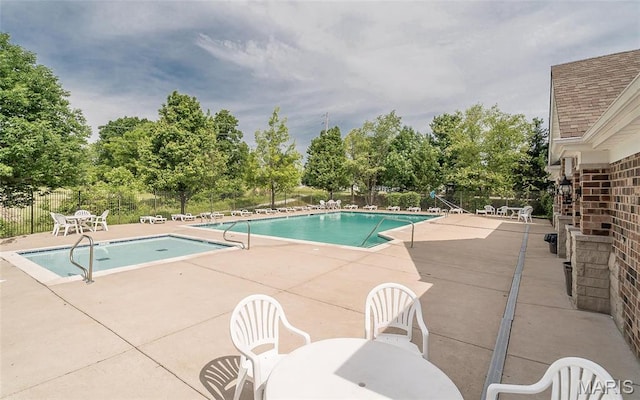 102 Carlton Point Dr, Wentzville, MO 63385 - community pool featuring a patio area and view of scattered trees