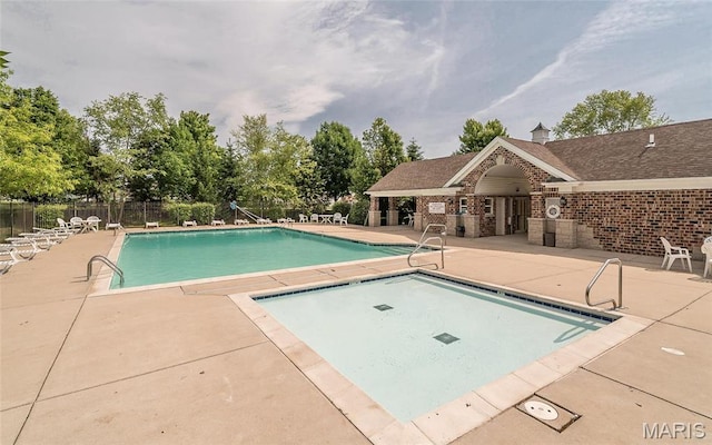 102 Carlton Point Dr, Wentzville, MO 63385 - community pool with a patio area and view of scattered trees