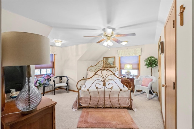 bedroom with light colored carpet, a ceiling fan, and baseboards