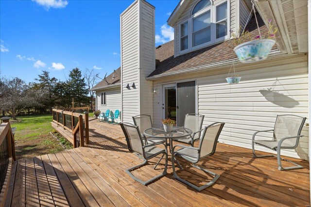 wooden terrace with outdoor dining space
