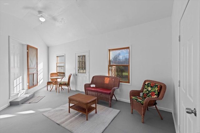 sitting room with lofted ceiling, plenty of natural light, baseboards, and a ceiling fan