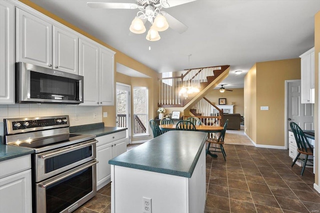 775 Vista Glen Ct, Eureka, MO 63025 - kitchen with appliances with stainless steel finishes, ceiling fan, dark countertops, white cabinets, and backsplash