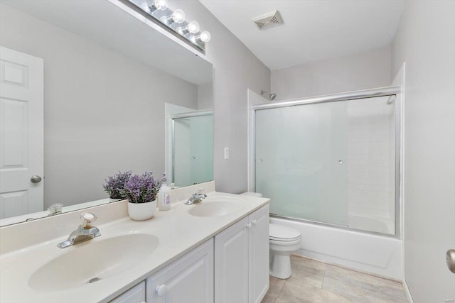775 Vista Glen Ct, Eureka, MO 63025 - bathroom with double vanity, combined bath / shower with glass door, tile patterned floors, and toilet