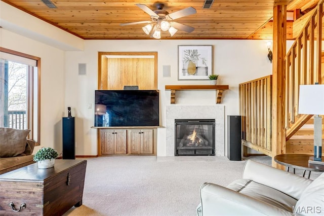 2208 N Konstanz Dr, Innsbrook, MO 63390 - carpeted living room with wood ceiling, ceiling fan, a lit fireplace, and stairs