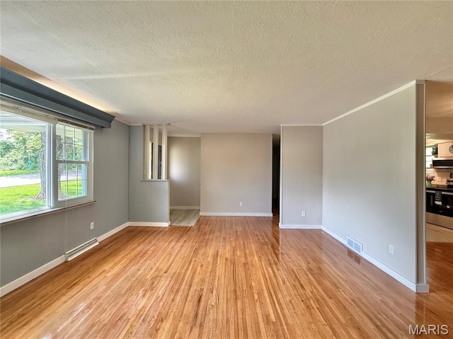 unfurnished room with light wood-style flooring, a textured ceiling, baseboards, and baseboard heating