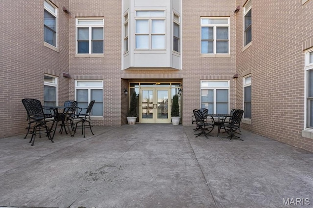 842 N New Ballas Ct Unit 303, Saint Louis, MO 63141 - view of patio with french doors and outdoor dining space