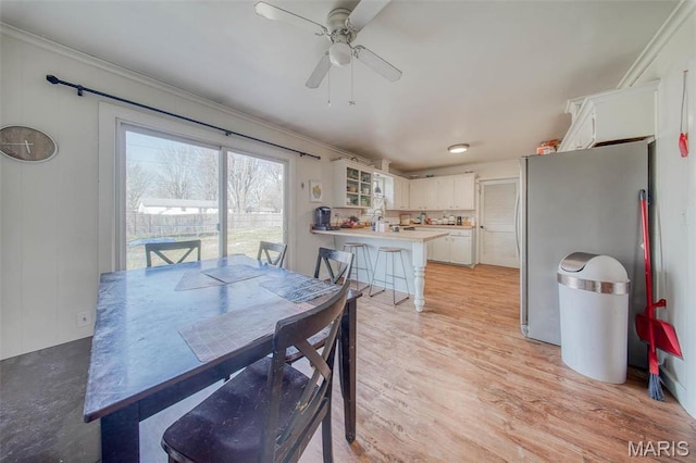 611 N Charles Ave, St James, MO 65559 - dining room with ceiling fan, ornamental molding, and light wood-type flooring