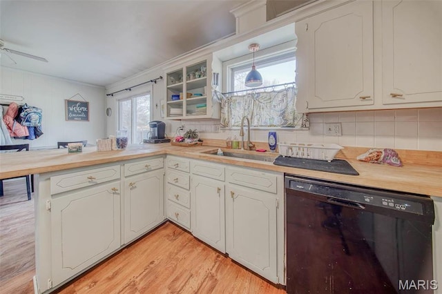 611 N Charles Ave, St James, MO 65559 - kitchen with black dishwasher, a sink, a peninsula, decorative backsplash, and ornamental molding
