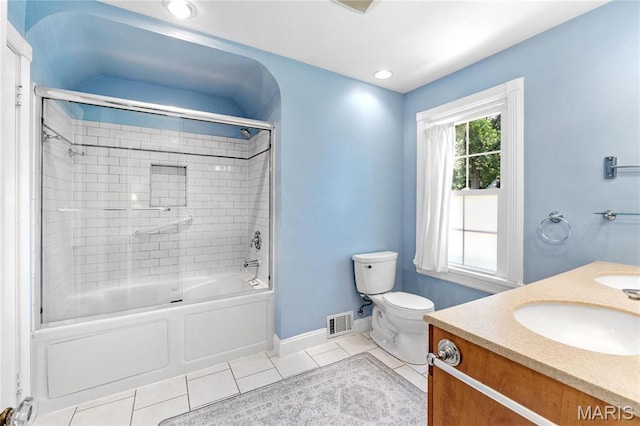 full bathroom with toilet, tile patterned floors, baseboards, combined bath / shower with glass door, and vanity