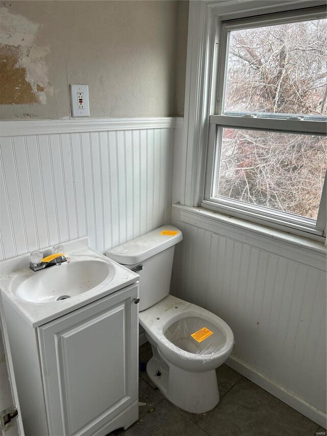 3804 Melba Pl, Saint Louis, MO 63121 - bathroom featuring a wainscoted wall, toilet, vanity, and tile patterned floors