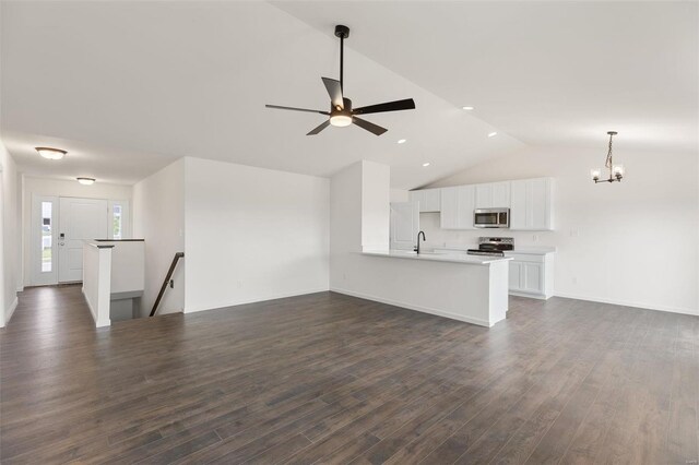 1028 Red Fox Dr, Eureka, MO 63025 - unfurnished living room with dark wood-type flooring, a chandelier, vaulted ceiling, a ceiling fan, and recessed lighting