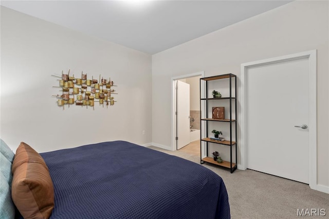 bedroom with light colored carpet and baseboards