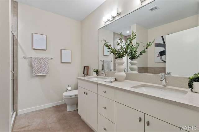 bathroom with toilet, baseboards, double vanity, tile patterned floors, and a shower with shower door
