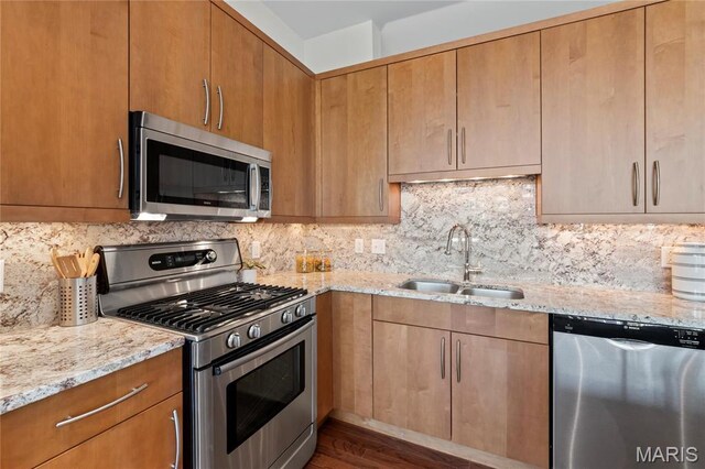 9 N Euclid Ave Unit 508, Saint Louis, MO 63108 - kitchen featuring stainless steel appliances, a sink, light stone counters, and backsplash