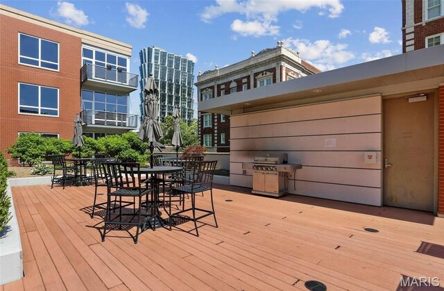 9 N Euclid Ave Unit 508, Saint Louis, MO 63108 - wooden terrace with a grill and outdoor dining area