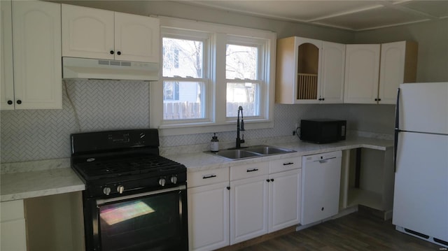 304 W 3rd St S, Mount Olive, IL 62069 - kitchen with black appliances, under cabinet range hood, a sink, tasteful backsplash, and dark wood-type flooring