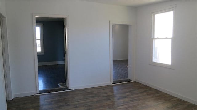 304 W 3rd St S, Mount Olive, IL 62069 - unfurnished bedroom with dark wood-type flooring and baseboards