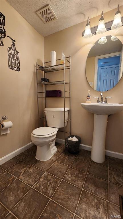 1147 Rue La Chelle Unit 1147, Creve Coeur, MO 63141 - half bath with a textured ceiling, toilet, and baseboards