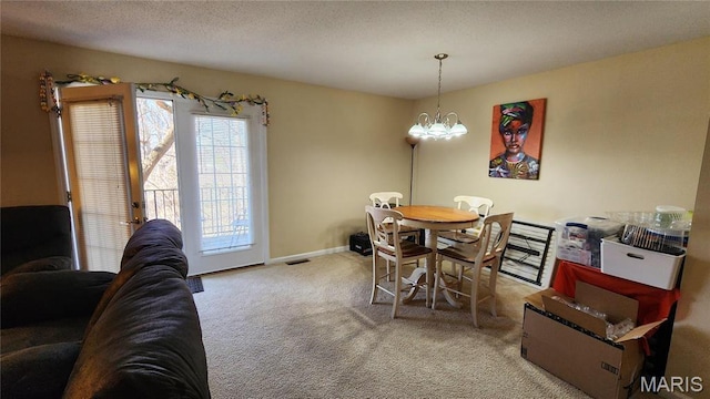 1147 Rue La Chelle Unit 1147, Creve Coeur, MO 63141 - carpeted dining area with a chandelier and baseboards