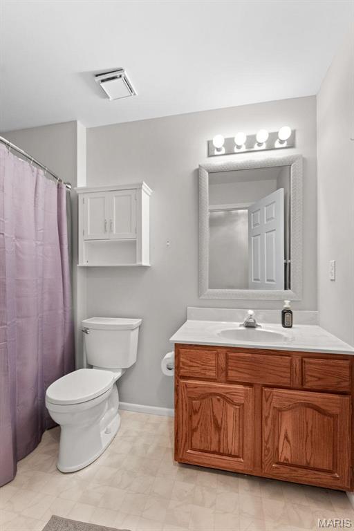 19120 Hawk Mountain Rd, Wildwood, MO 63038 - bathroom with toilet, vanity, tile patterned floors, and baseboards