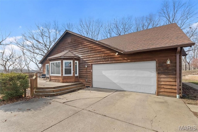 19120 Hawk Mountain Rd, Wildwood, MO 63038 - view of front of home featuring roof with shingles, driveway, an attached garage, and a wooden deck