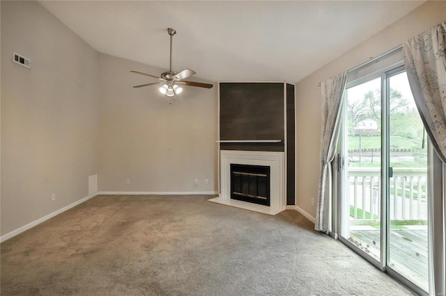 1626 High School Dr, Saint Louis, MO 63144 - unfurnished living room featuring carpet flooring, a ceiling fan, a fireplace, baseboards, and lofted ceiling