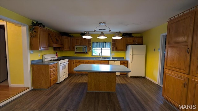 kitchen with white appliances, dark wood-type flooring, a sink, and premium range hood