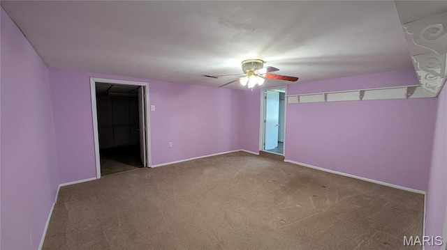unfurnished room with carpet, ceiling fan, and baseboards