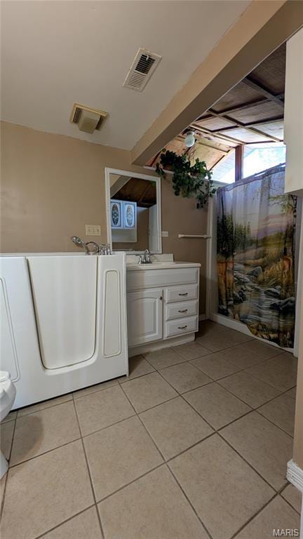 laundry room with light tile patterned floors and a sink