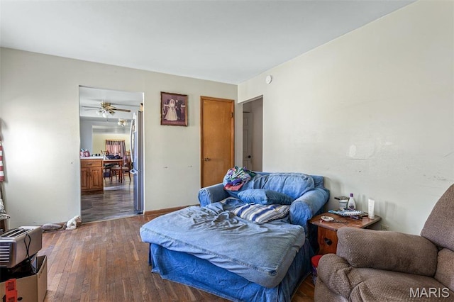 4279 Ee Hwy, Farmington, MO 63640 - bedroom with freestanding refrigerator, dark wood-type flooring, and baseboards