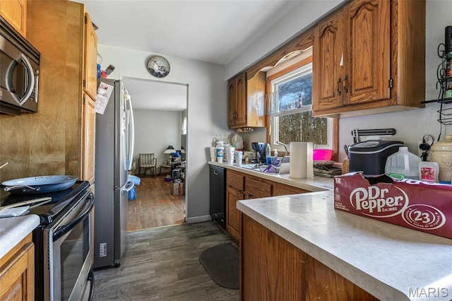 4279 Ee Hwy, Farmington, MO 63640 - kitchen with black appliances, brown cabinets, dark wood-style flooring, and light countertops
