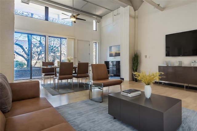 4100 Laclede Ave Unit 110, Saint Louis, MO 63108 - living area with a high ceiling, ceiling fan, and wood finished floors