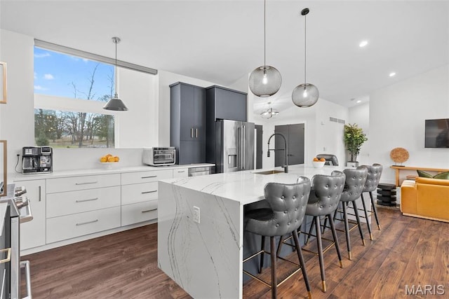 3545 Cappeln Osage Rd, Marthasville, MO 63357 - kitchen featuring appliances with stainless steel finishes, modern cabinets, a kitchen bar, dark wood-style flooring, and recessed lighting