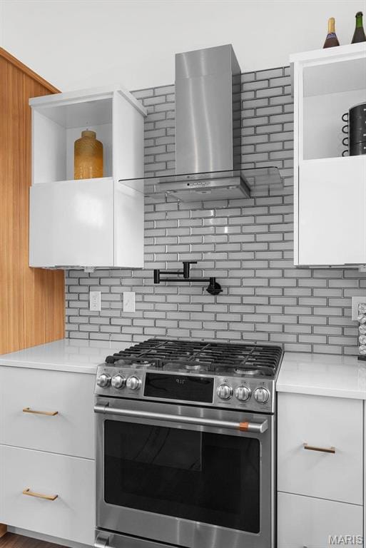 3545 Cappeln Osage Rd, Marthasville, MO 63357 - kitchen featuring stainless steel gas range, wall chimney exhaust hood, light countertops, tasteful backsplash, and white cabinets
