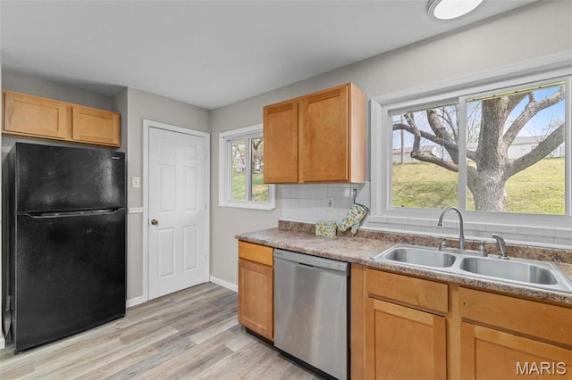 190 Coteau Ln, Florissant, MO 63033 - kitchen featuring freestanding refrigerator, dishwasher, a sink, and plenty of natural light