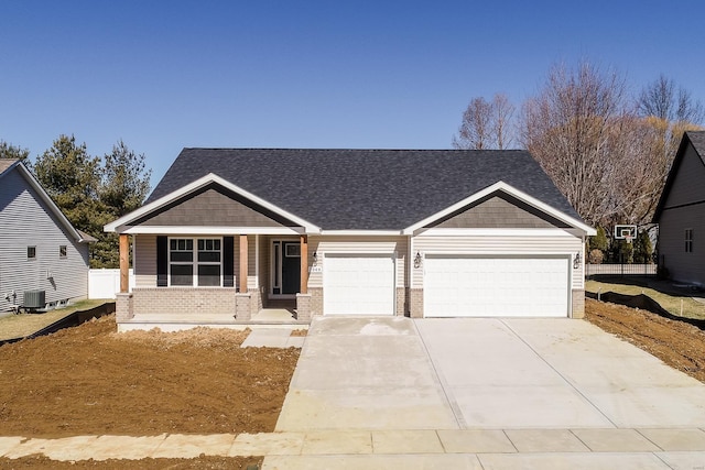 7349 Providence, Edwardsville, IL 62025 - craftsman-style home featuring brick siding, an attached garage, covered porch, and driveway