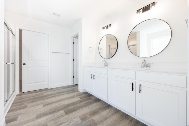 7349 Providence, Edwardsville, IL 62025 - full bathroom with wood finished floors, double vanity, and a shower with shower door