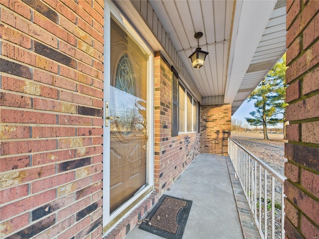 doorway to property with brick siding