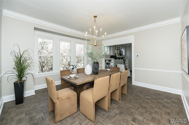7642 Westmoreland Ave, Saint Louis, MO 63105 - dining space with a chandelier, baseboards, and crown molding