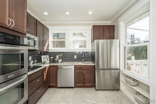 7642 Westmoreland Ave, Saint Louis, MO 63105 - kitchen featuring stainless steel appliances, a sink, ornamental molding, tasteful backsplash, and light stone counters