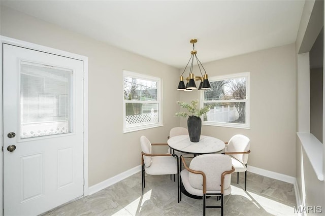 7642 Westmoreland Ave, Saint Louis, MO 63105 - dining area with baseboards and a chandelier